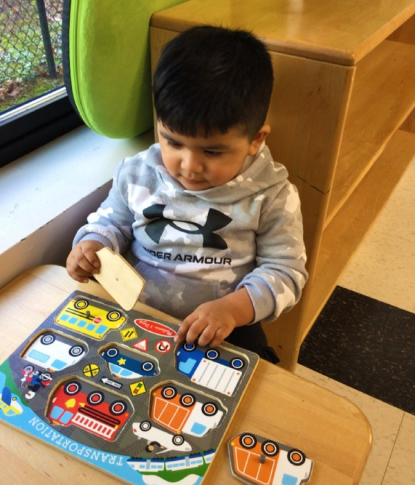 Montessori student completing a puzzle